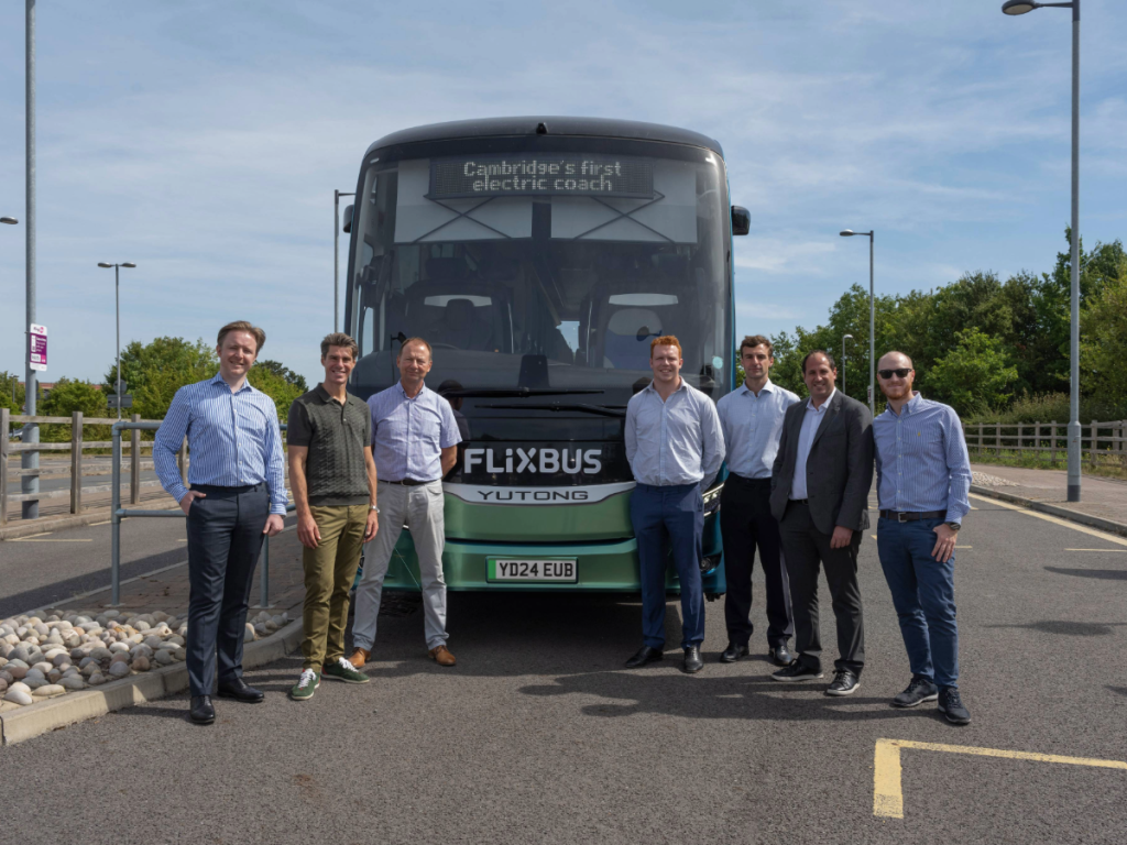 Representative from FlixBus, Zenobe and Whippet standing in front of Yutong GTe14 electric coach