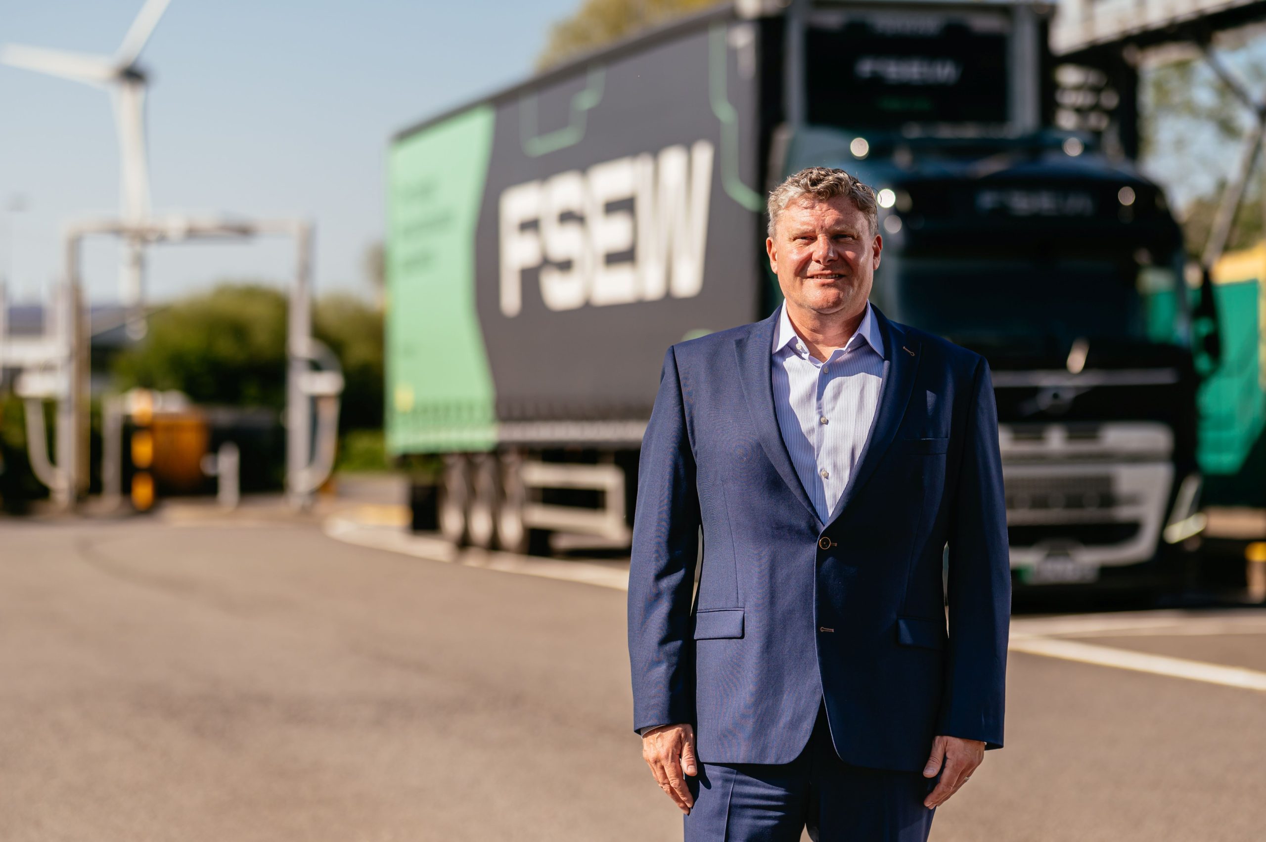 Geoff Tomlinson, MD of FSEW standing in front of an electric truck
