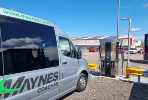 Electric minibue plugged into a Zenobe branded charger