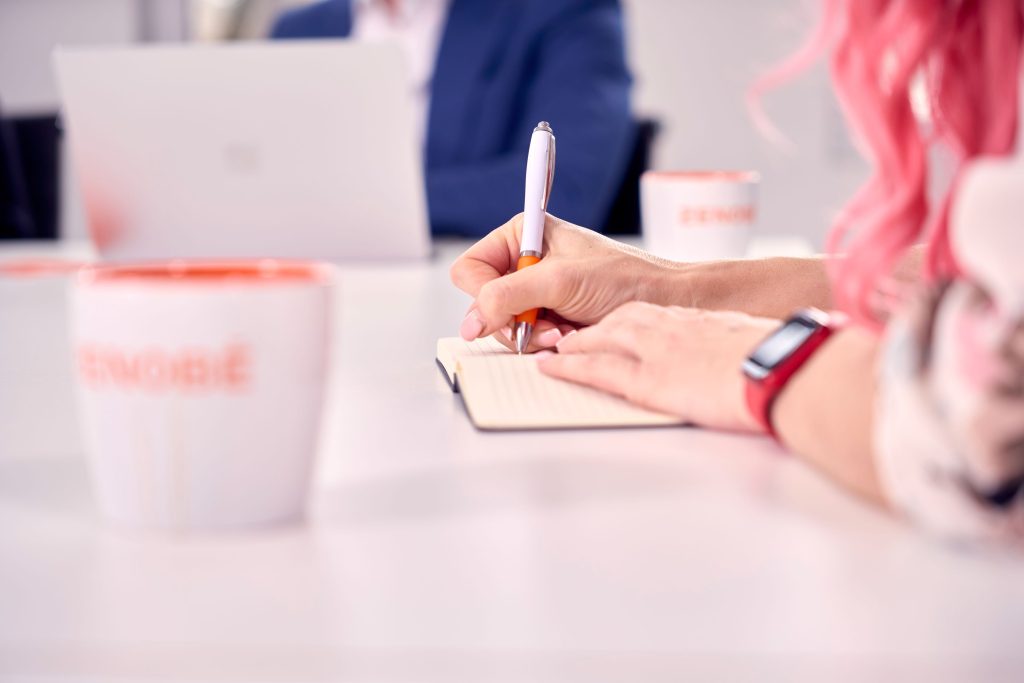 Woman writing on a note book