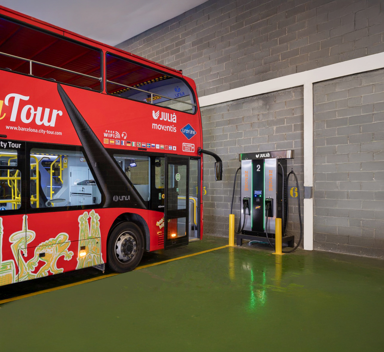 Grupo Julia electric bus plugged in to a Zenobe branded charger