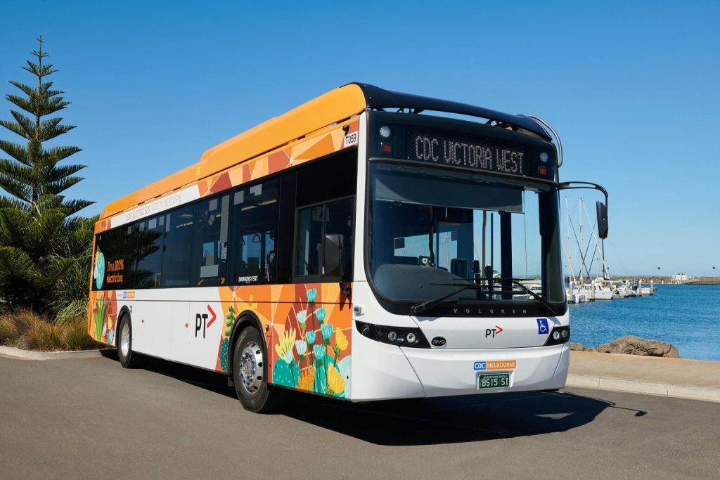 Image of a ComfortDelGro electric bus parked next to a harbour